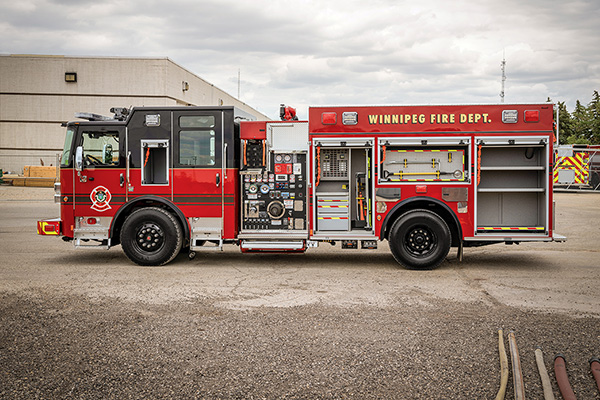 Drivers side of red pumper fire truck with compartment open