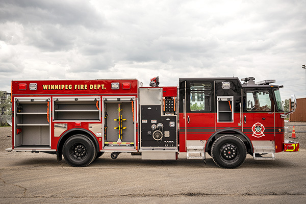 Officers side of pumper fire truck with compartment doors open