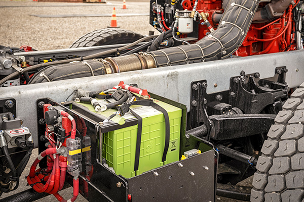 Fire truck cab tilted up showing engine and idle reduction green technology