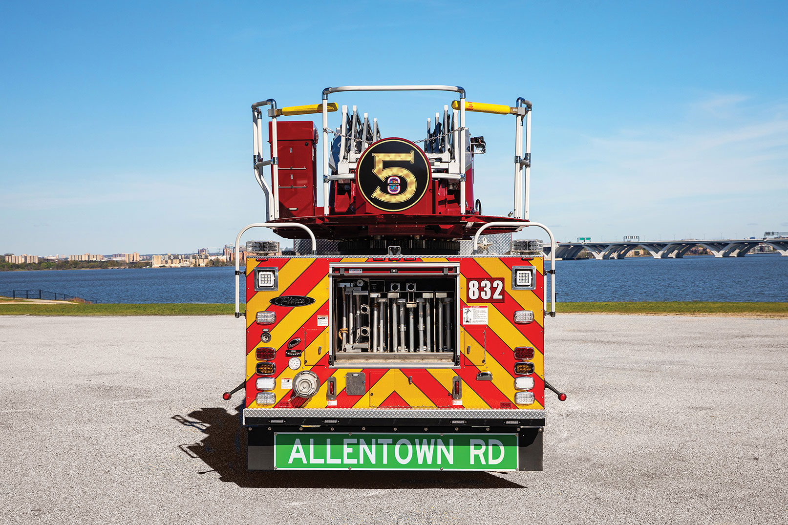 Ground ladder storage on aerial ladder fire apparatus