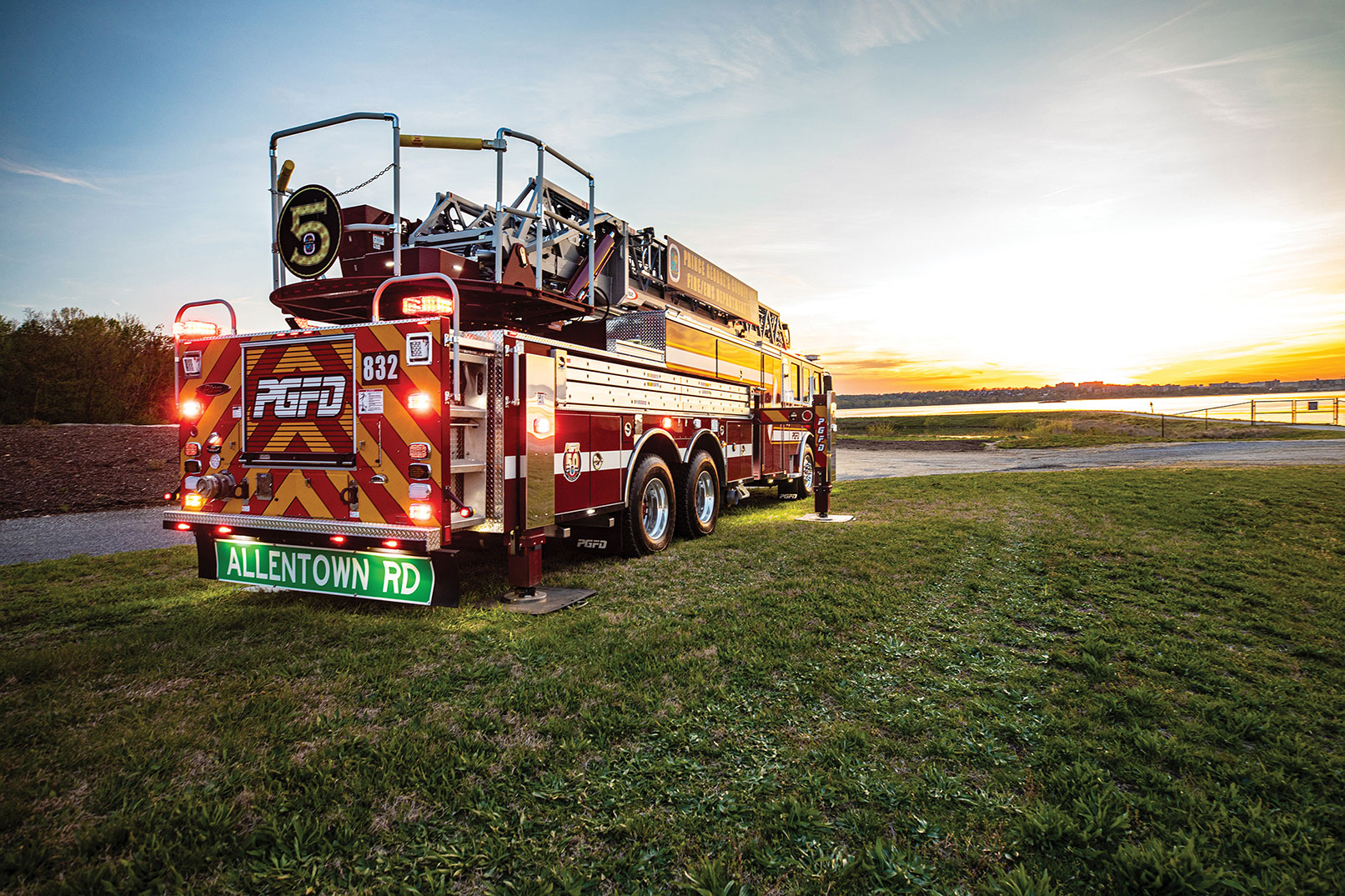 Rear of aerial ladder fire truck with emergency lights flashing