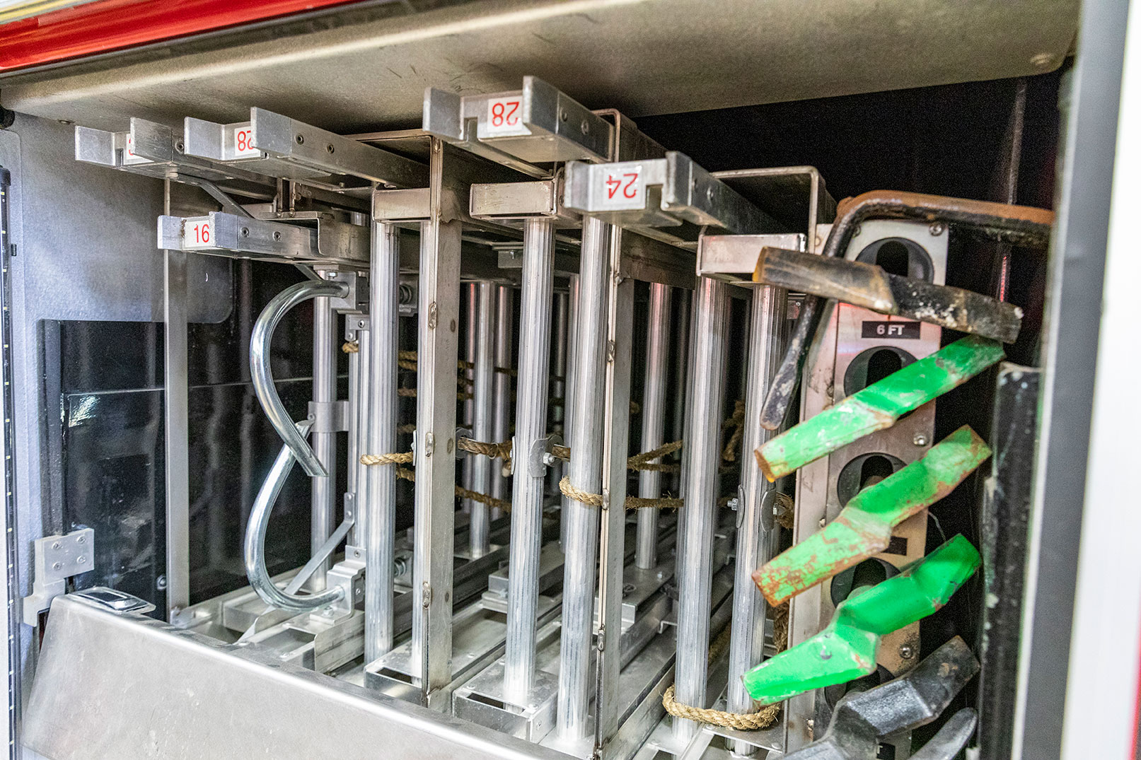 The ground ladders stowed in the rear compartment of an aerial fire truck.