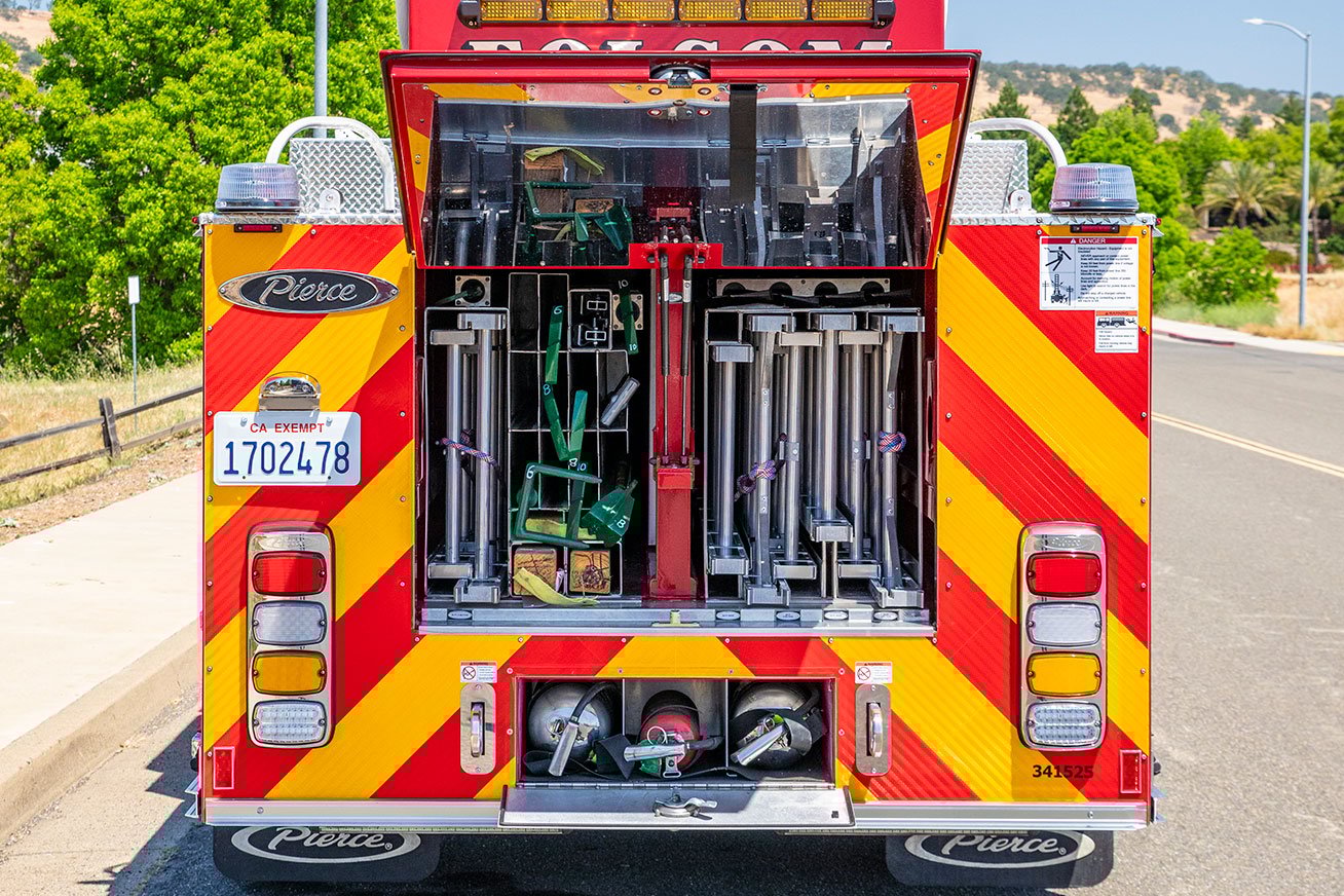 The rear of a Tractor Drawn Aerial with the compartments open showing ground ladders and air bottles.