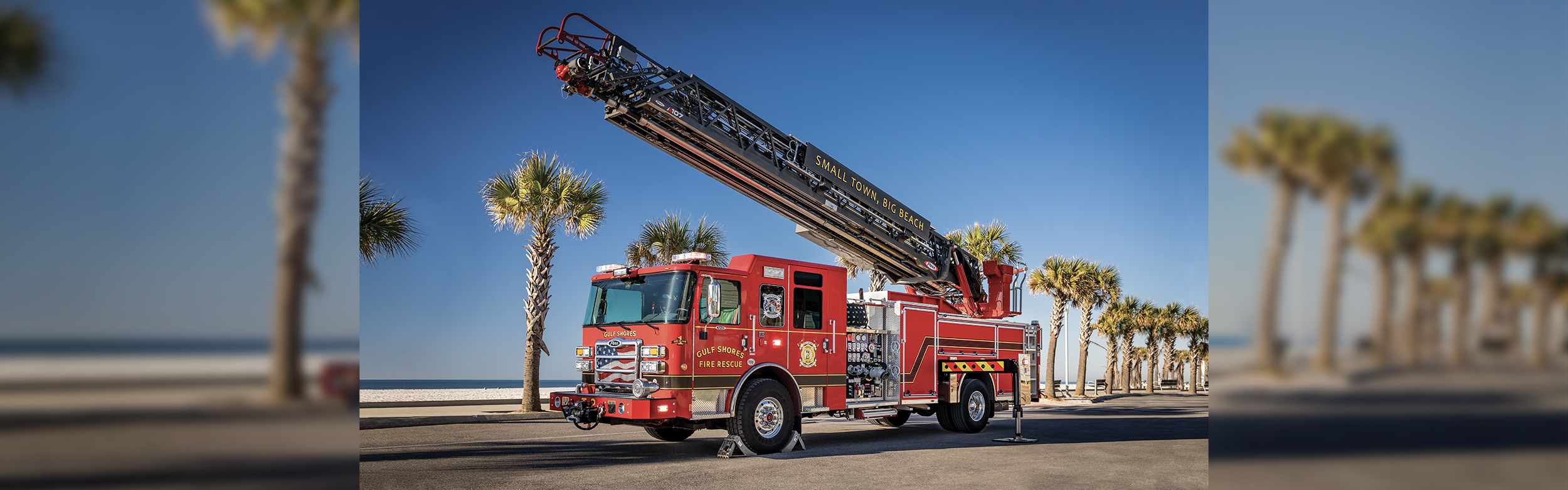 An Enforcer Ascendant 107' Heavy Duty Aerial Ladder - Single Rear Axle parked by a beach with the aerial up.