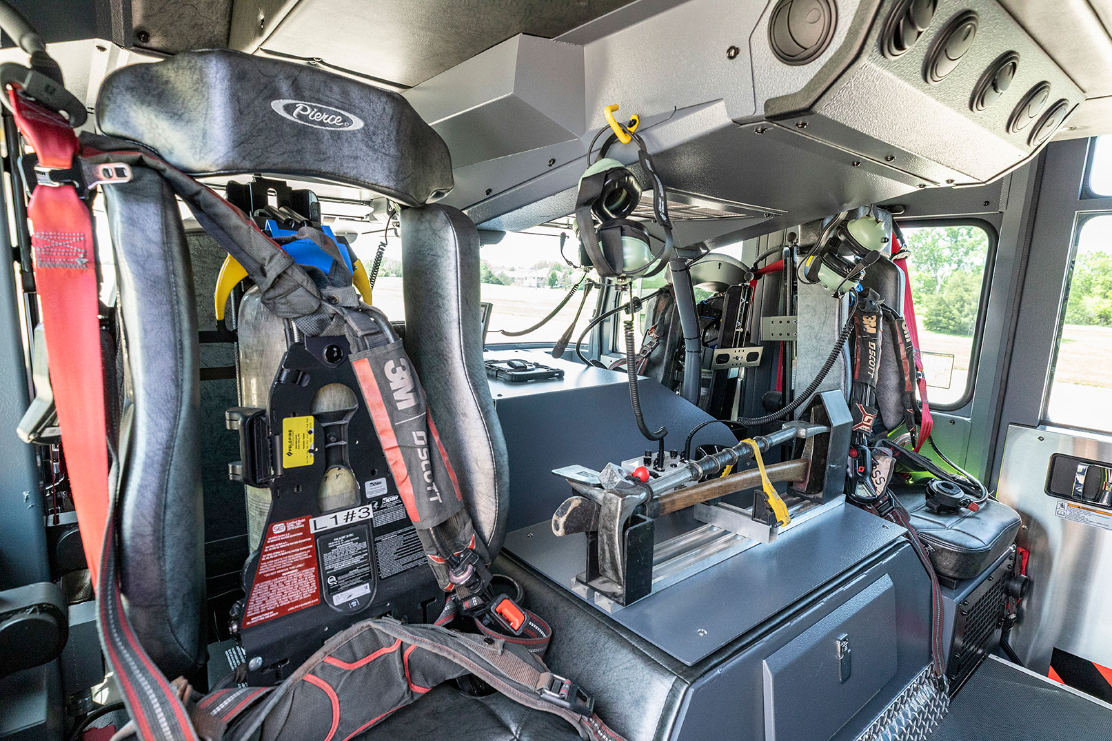 The crew cab of a fire truck with seats for firefighters with SCBAs and handtools.