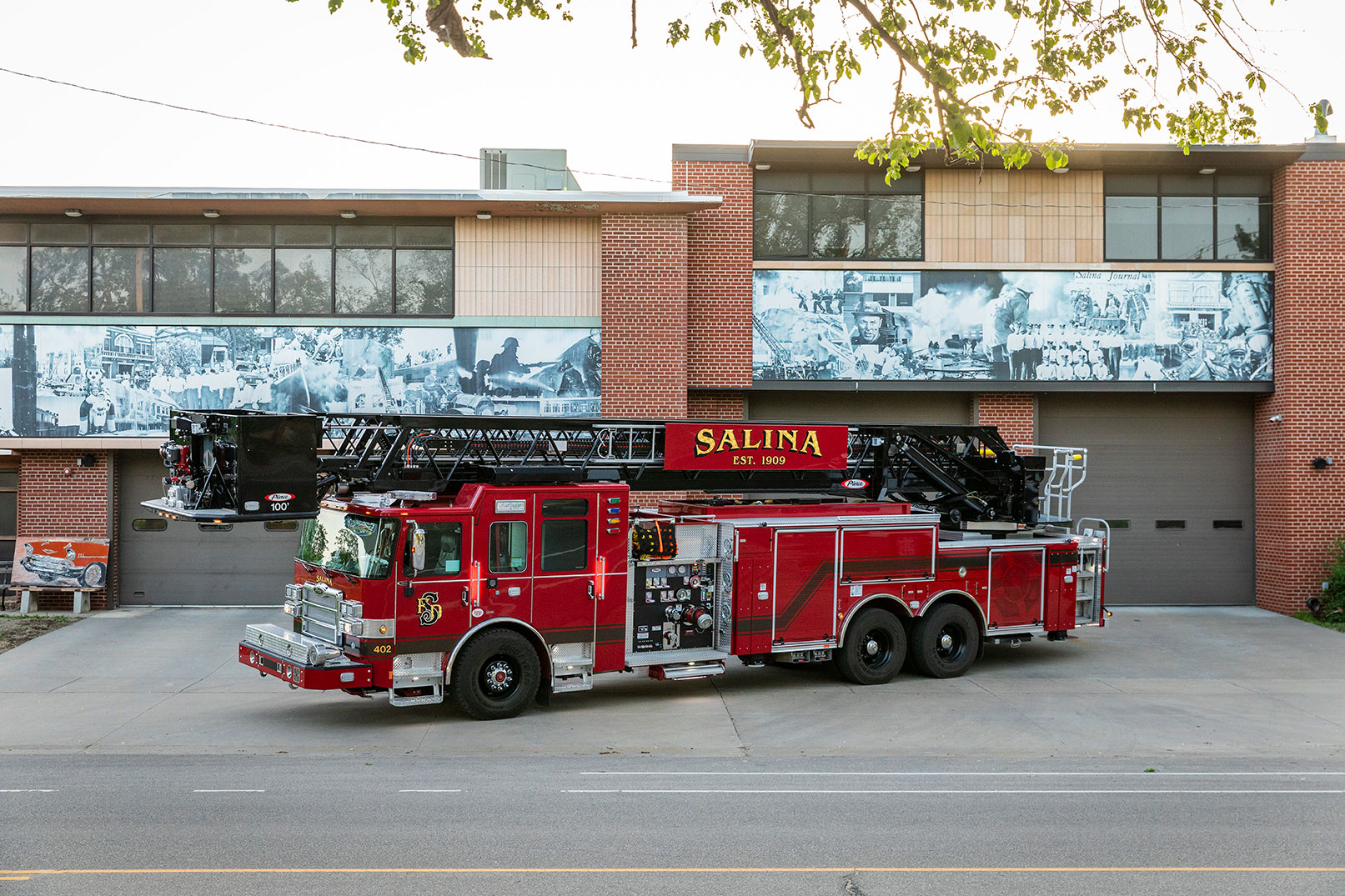 The drivers side of an Enforcer 100 Heavy-Duty Steel Aerial Platform parked in front of a brick building.