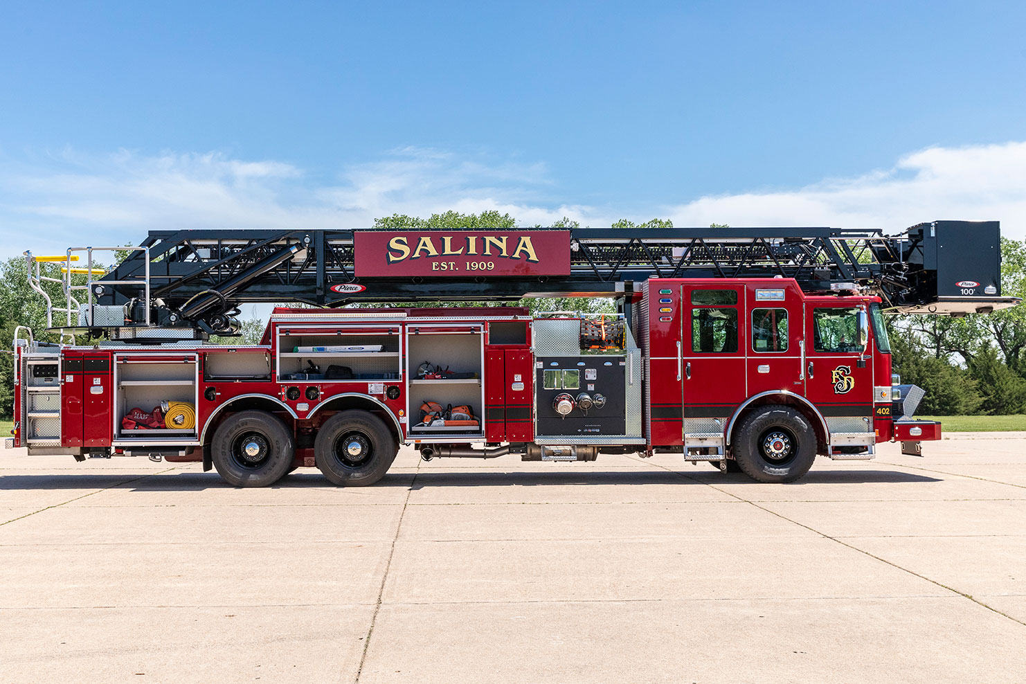 The officers side of an Enforcer 100 Heavy-Duty Steel Aerial Platform with the compartments open showing equipment inside.