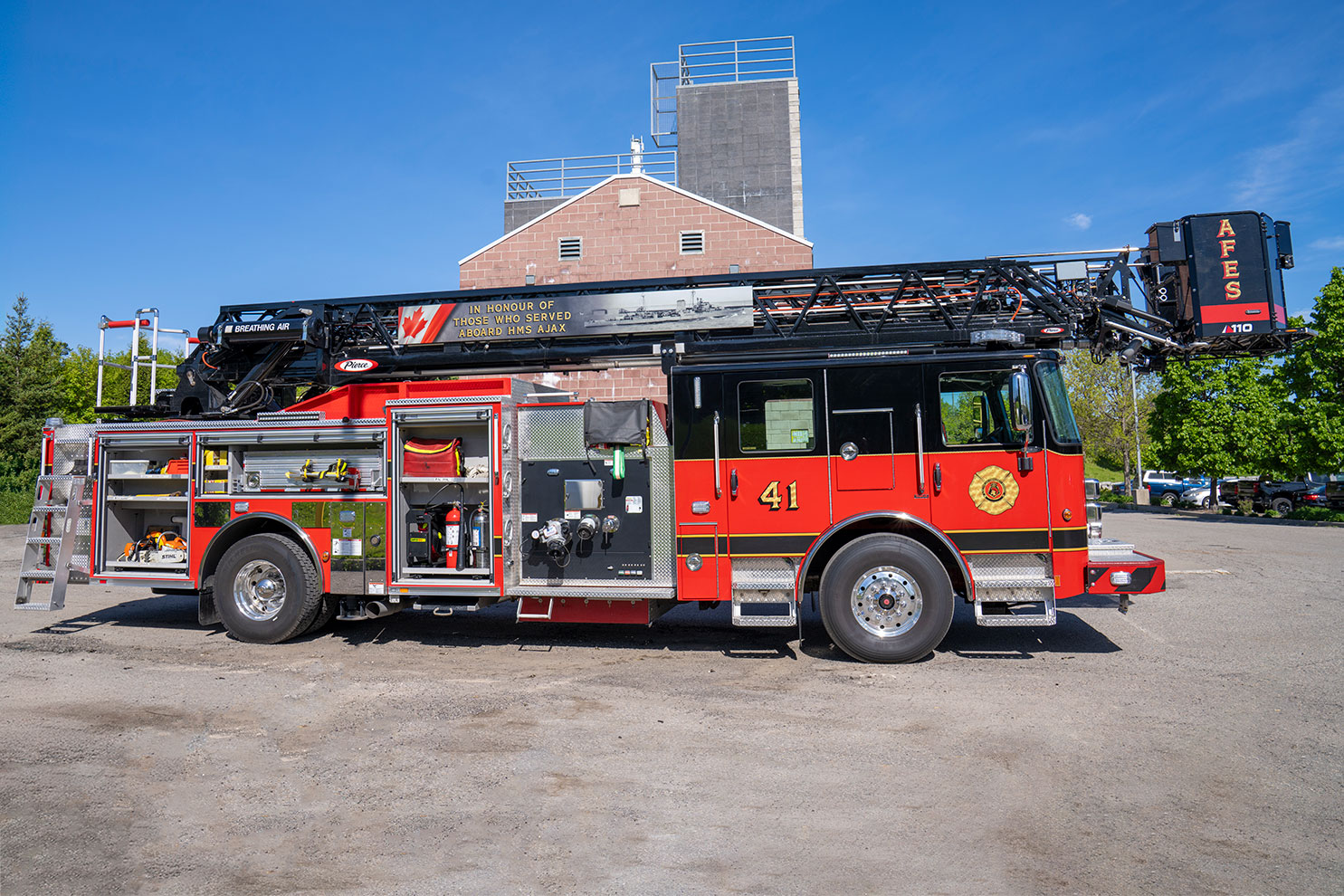 The officers side of an Enforcer 110 Ascendant Aerial Platform with the compartments open showing equipment and tools inside.