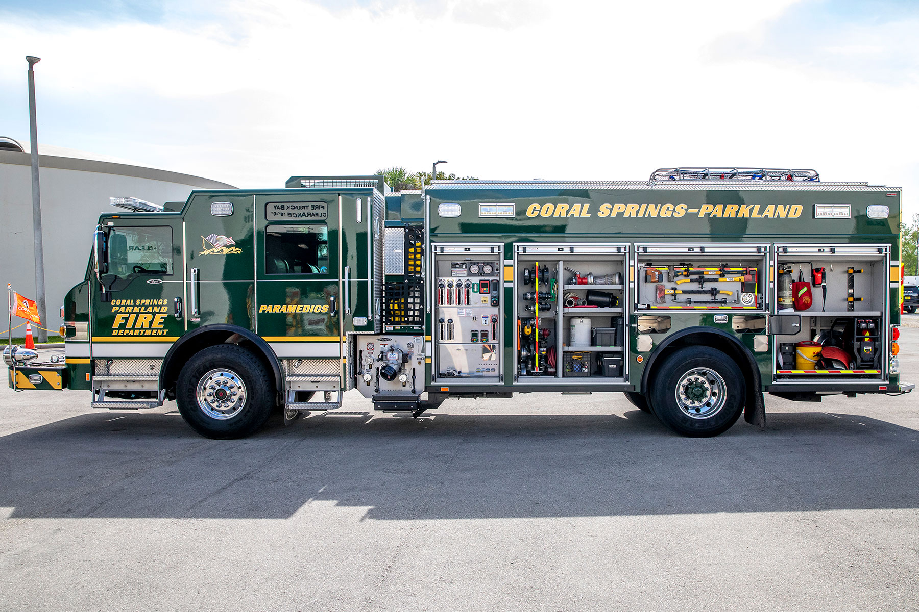 The drivers side of an Impel PUC Pumper with the compartments open with tools and equipment stored inside.