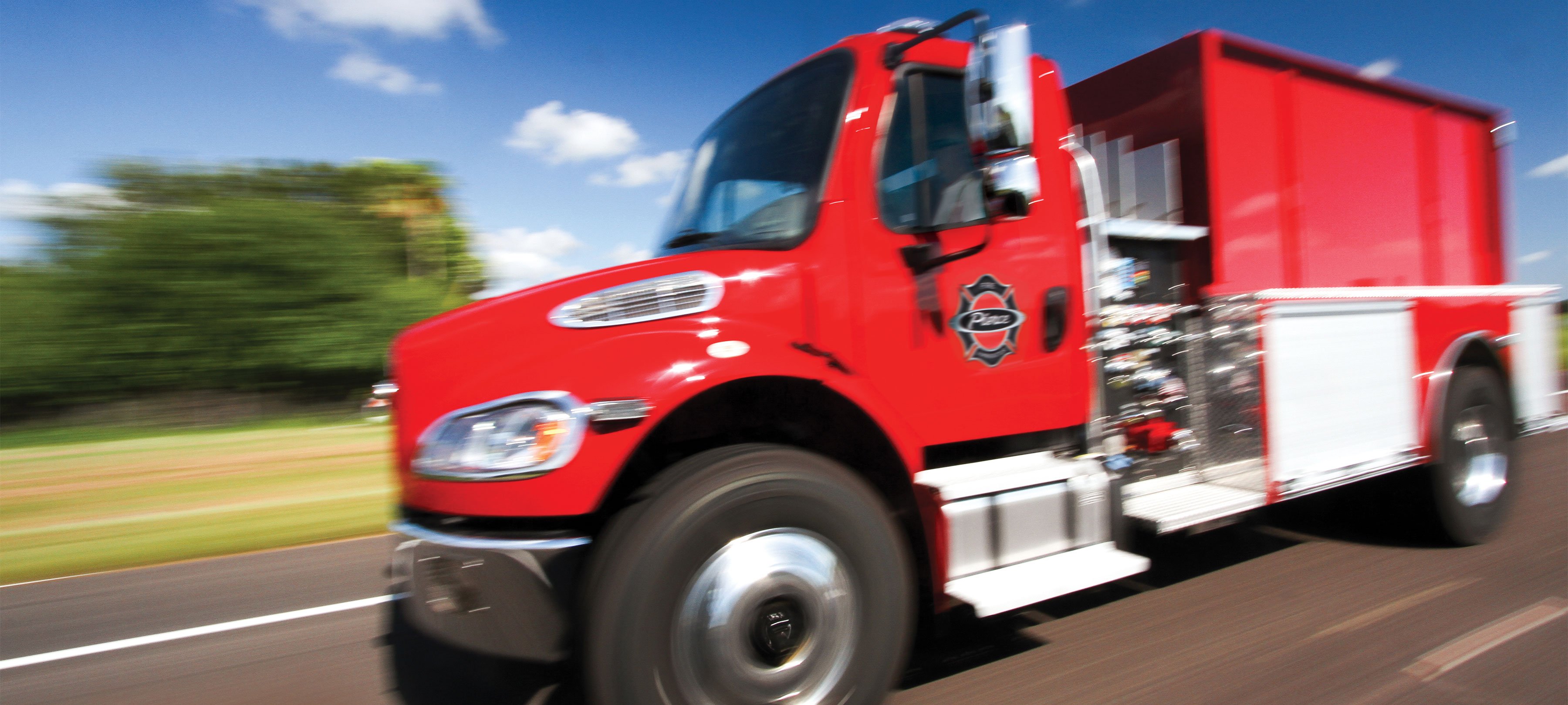 Pierce Ford Commercial fire truck chassis driving down the road.  