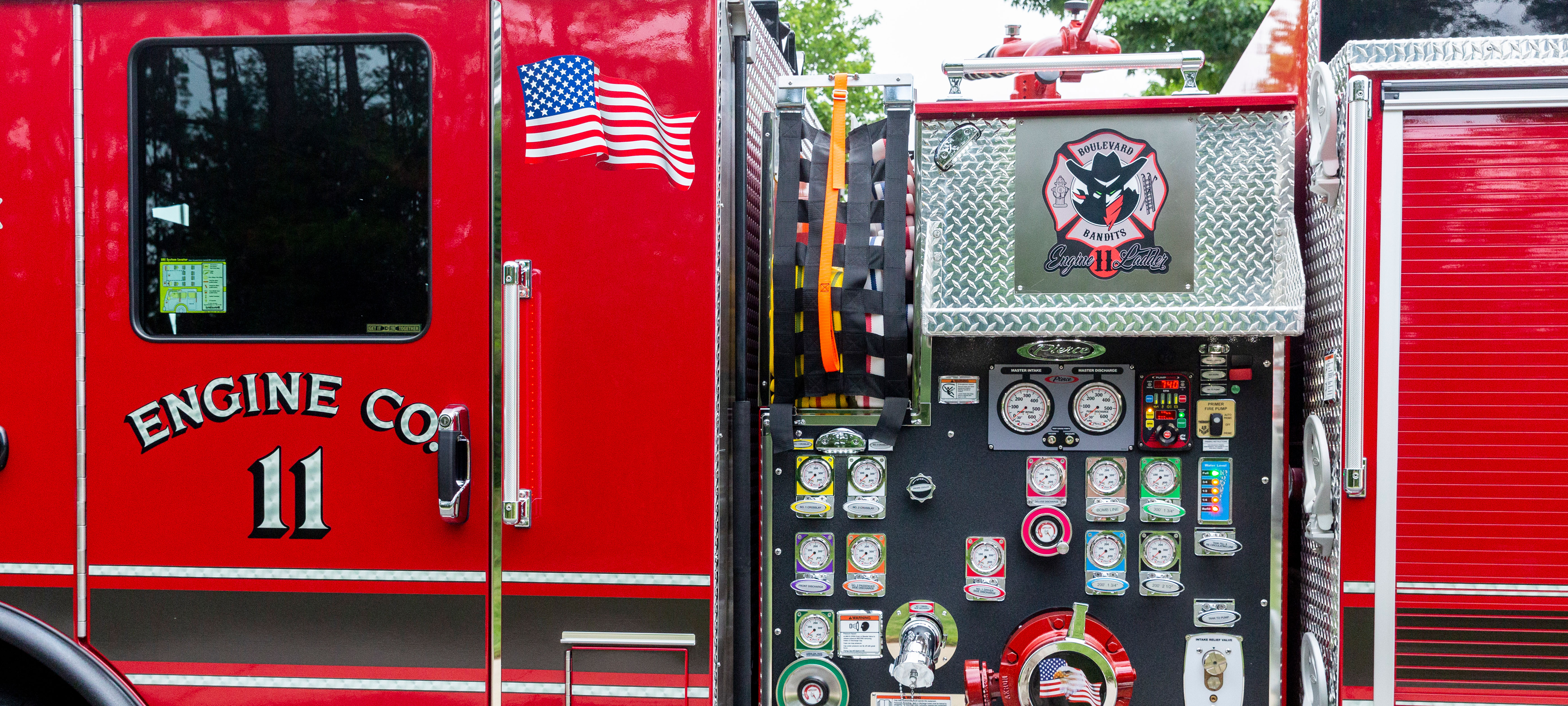 Pump panel with Crosslays behind the cab on the driver’s side of a Pierce Fire Truck. 