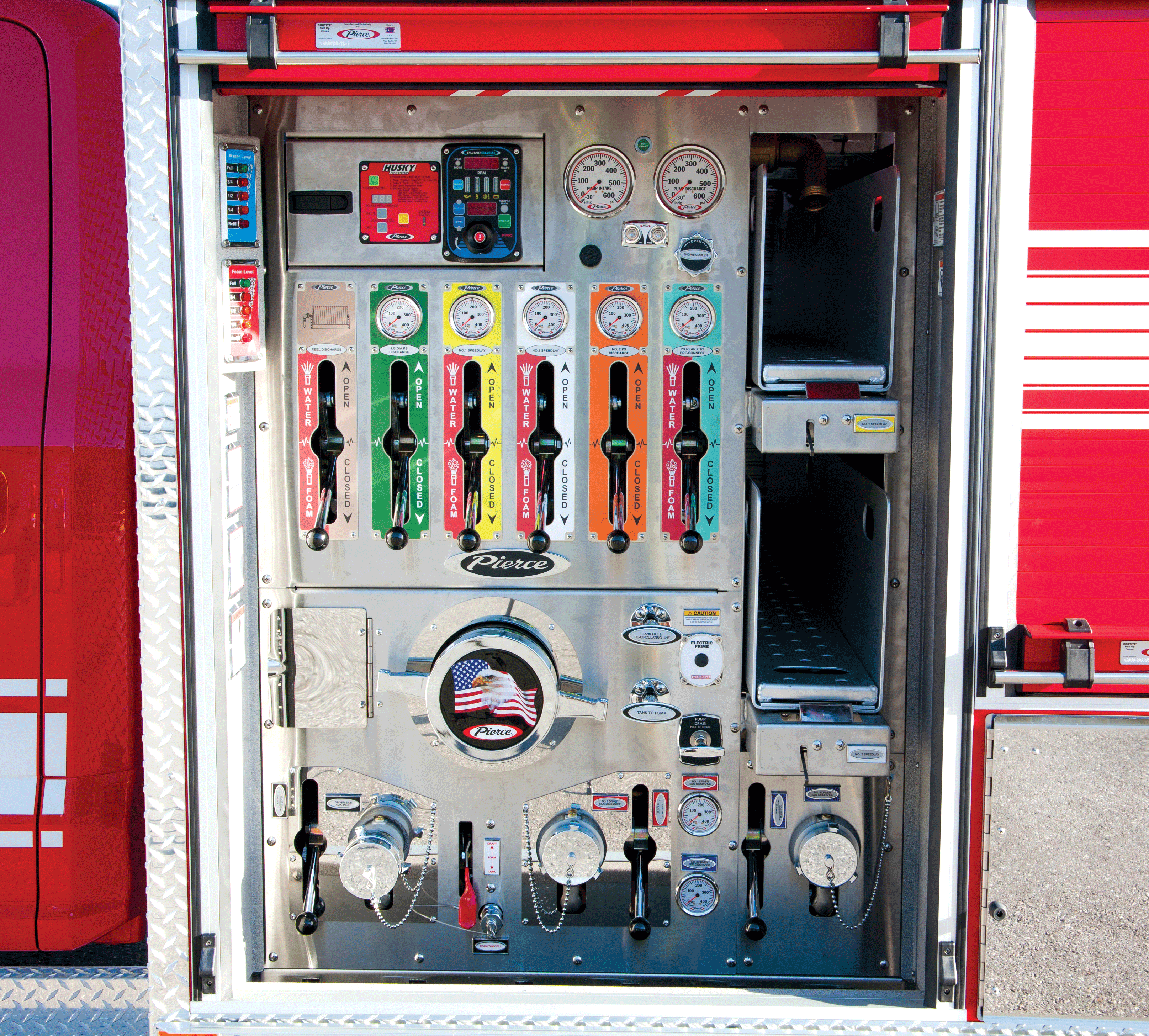 Pierce Ford Commercial Fire Truck Chassis rolling door opened to show the pump panel configuration. 