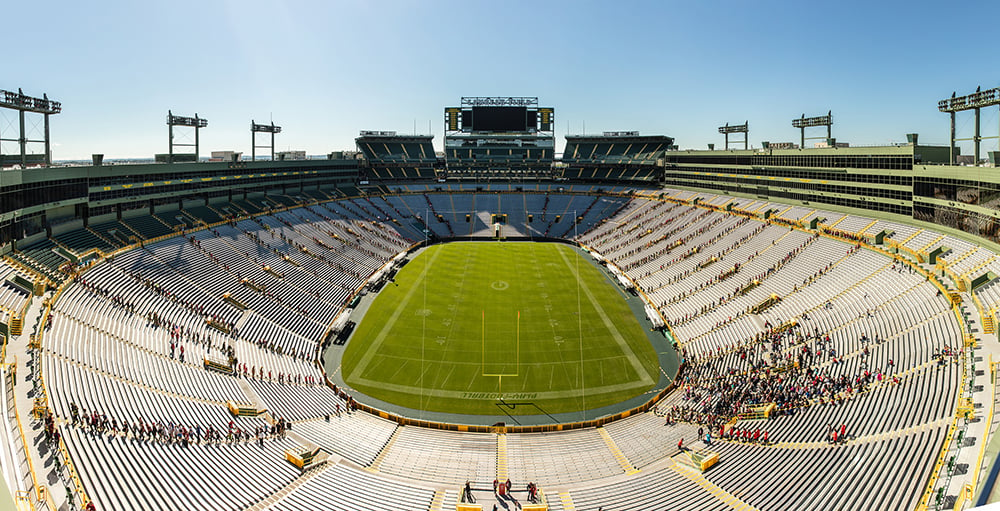 Lambeau Field with people climbing the bleacher stairs at the Pierce Manufacturing Memorial Stair Climb Event.