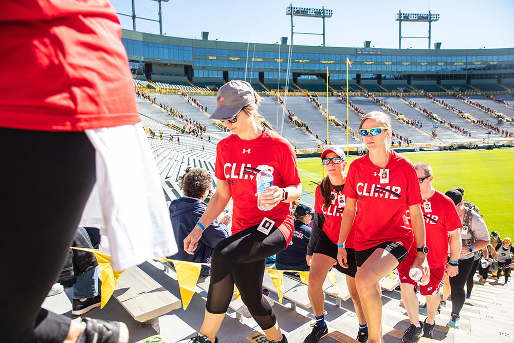 People Climbing the stairs of Lambeau Field on a sunny day for the Pierce Manufacturing 9/11 Memorial Stair Climb Event.