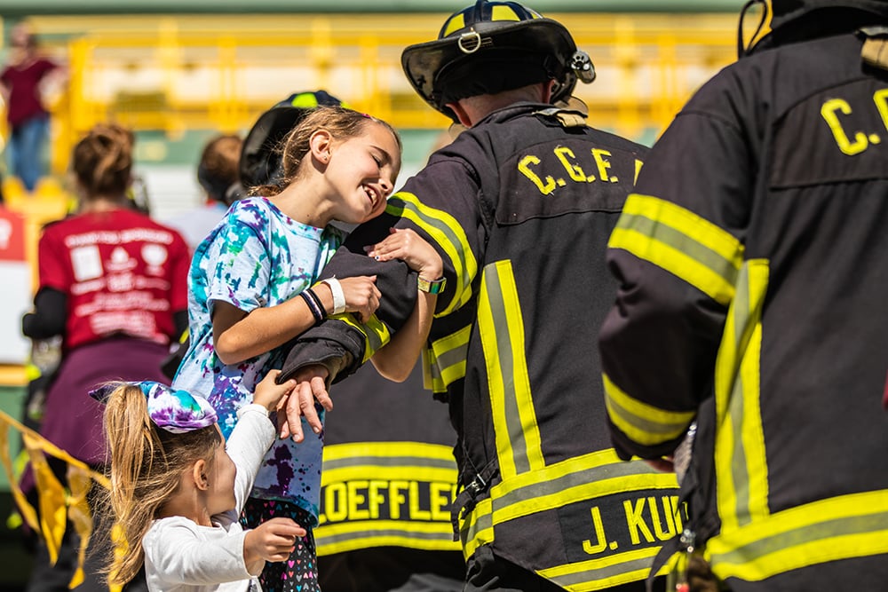 Firefighters in turnout gear climbing the stairs on Lambeau Field at the Pierce Manufacturing 9/11 Stair Climb Event.