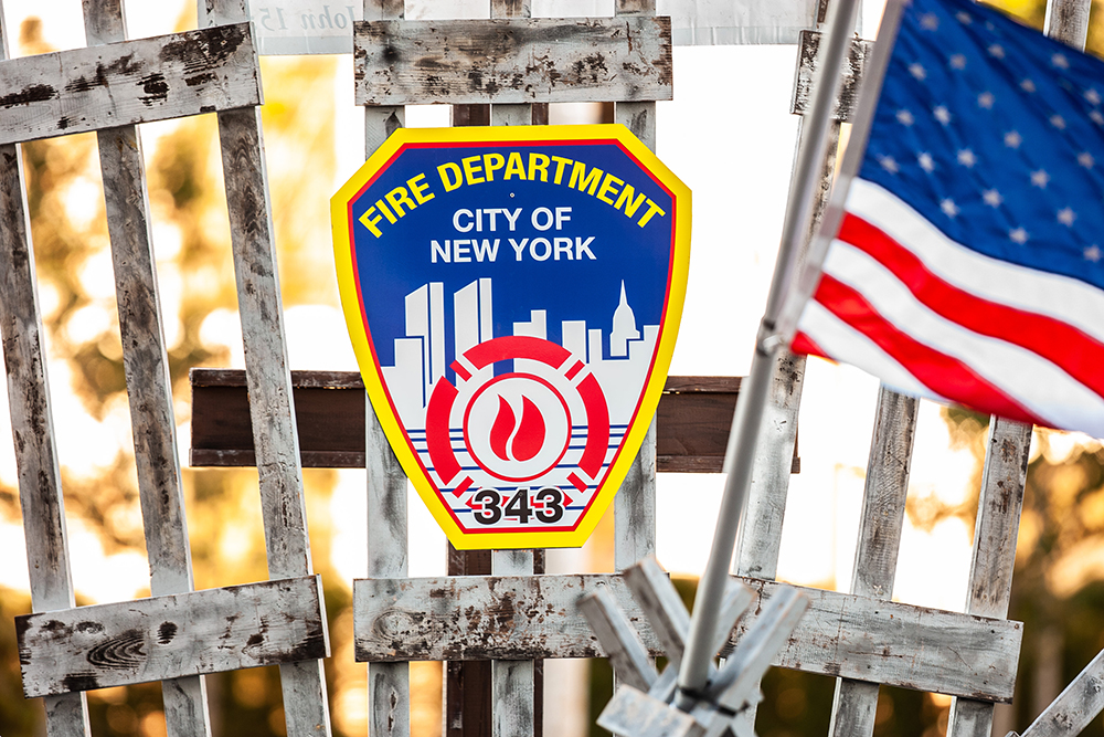 A memorial for the New York City Fire Department next to an American Flag at the Pierce Manufacturing 9/11 Memorial Stair Climb Event.