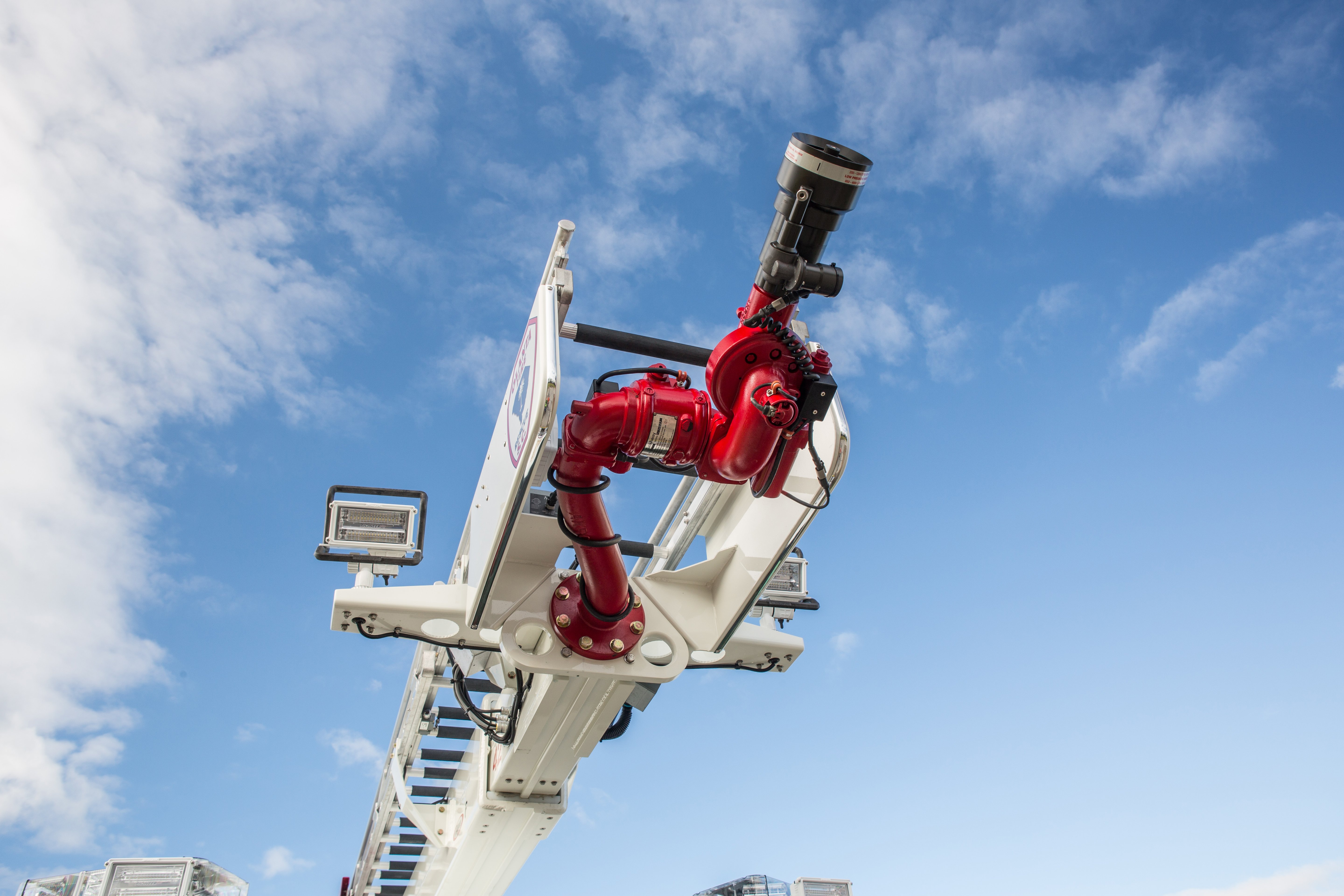 Pierce Heavy-Duty Sky-Boom Aerial Water Tower nozzle ascending into the sky. 