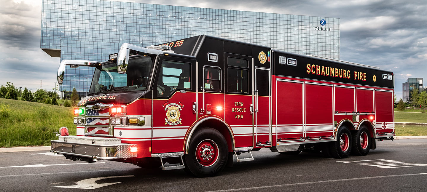 Pierce Rescue Fire Truck parked outside in a parking lot outside of a building. 