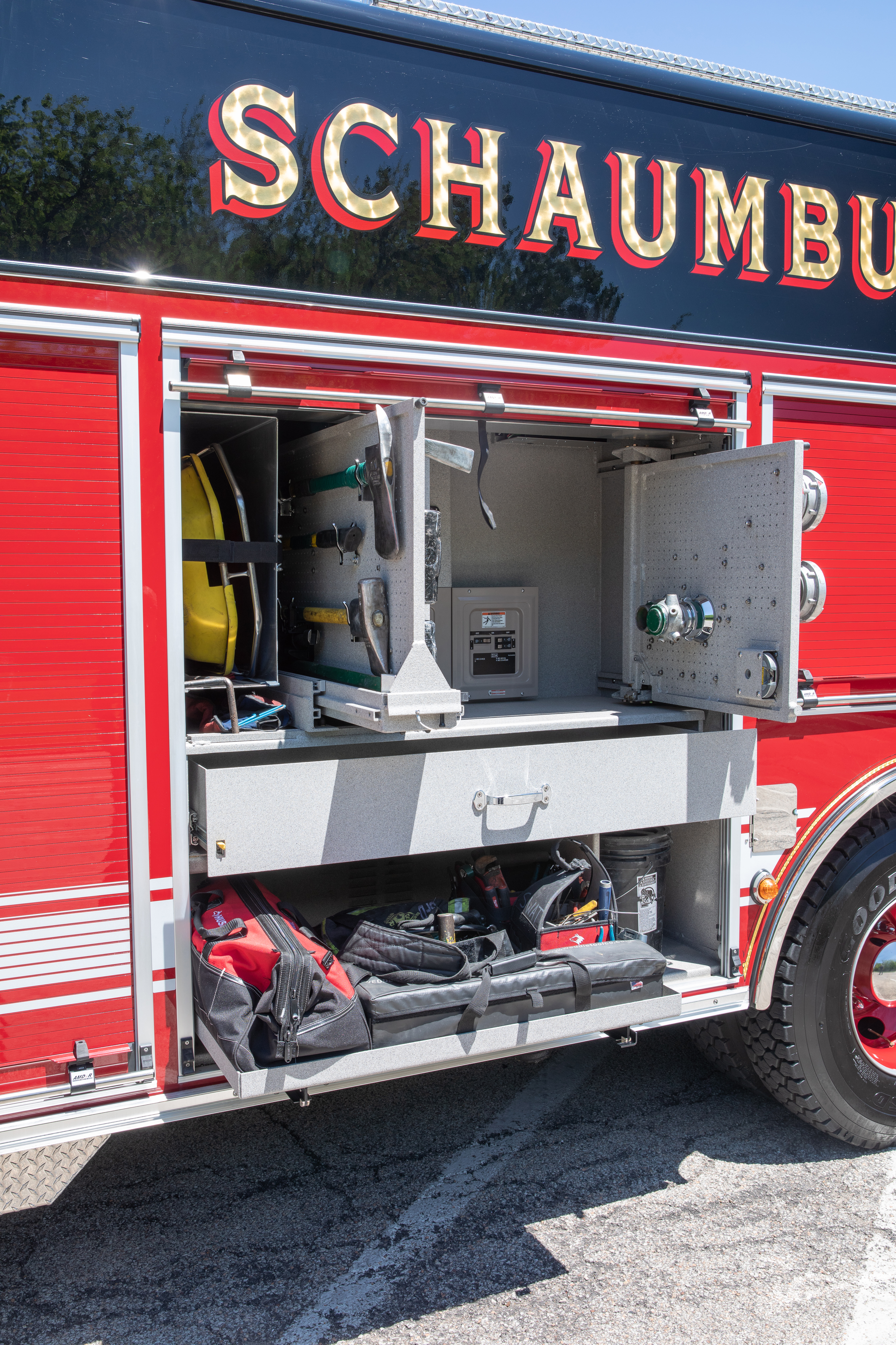 Pierce Non-Walk-In Rescue Fire Truck parked outside with side compartments open showing storage space. 