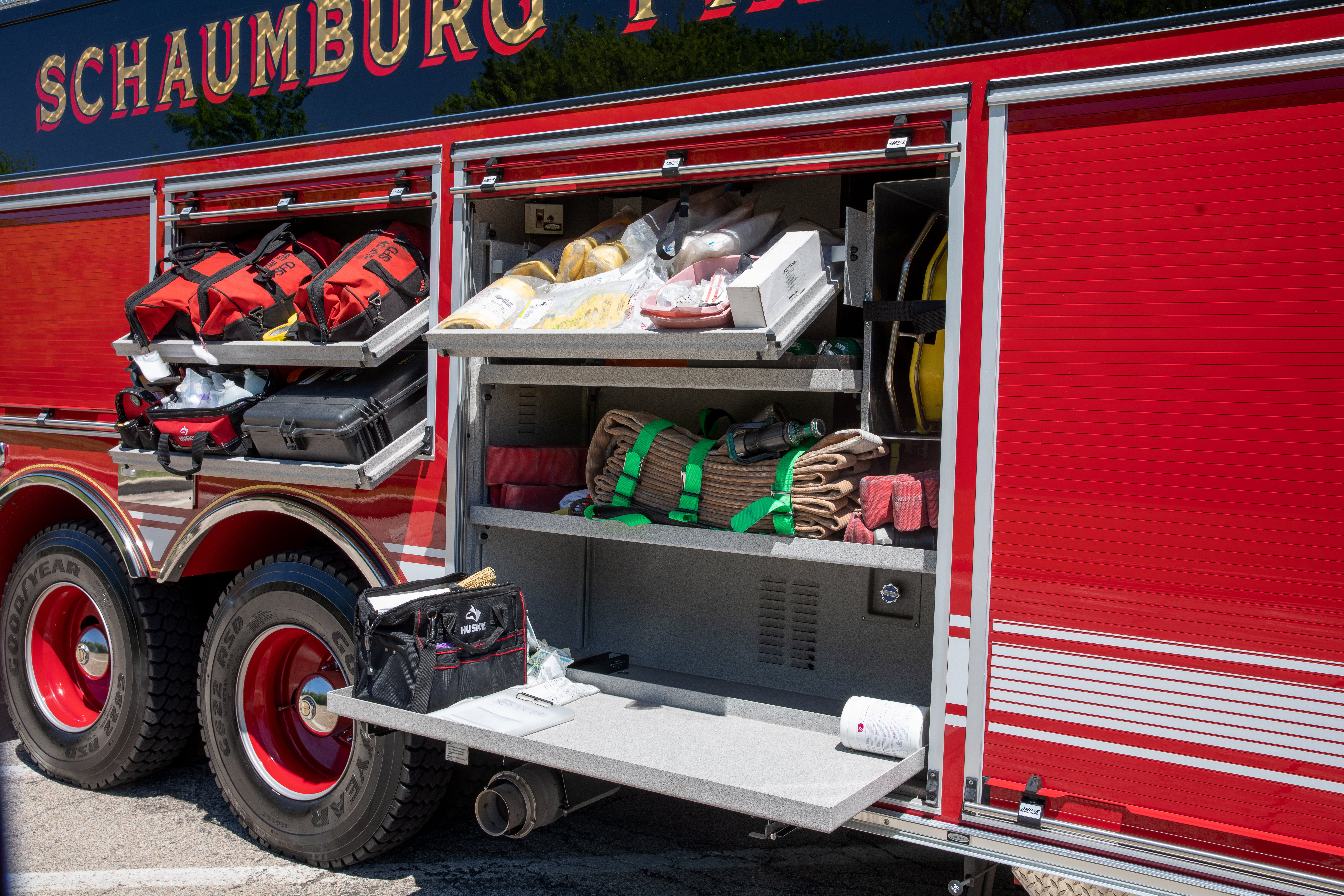 Pierce Non-Walk-In Rescue Fire Truck with side pull out compartments open showing storage space. 