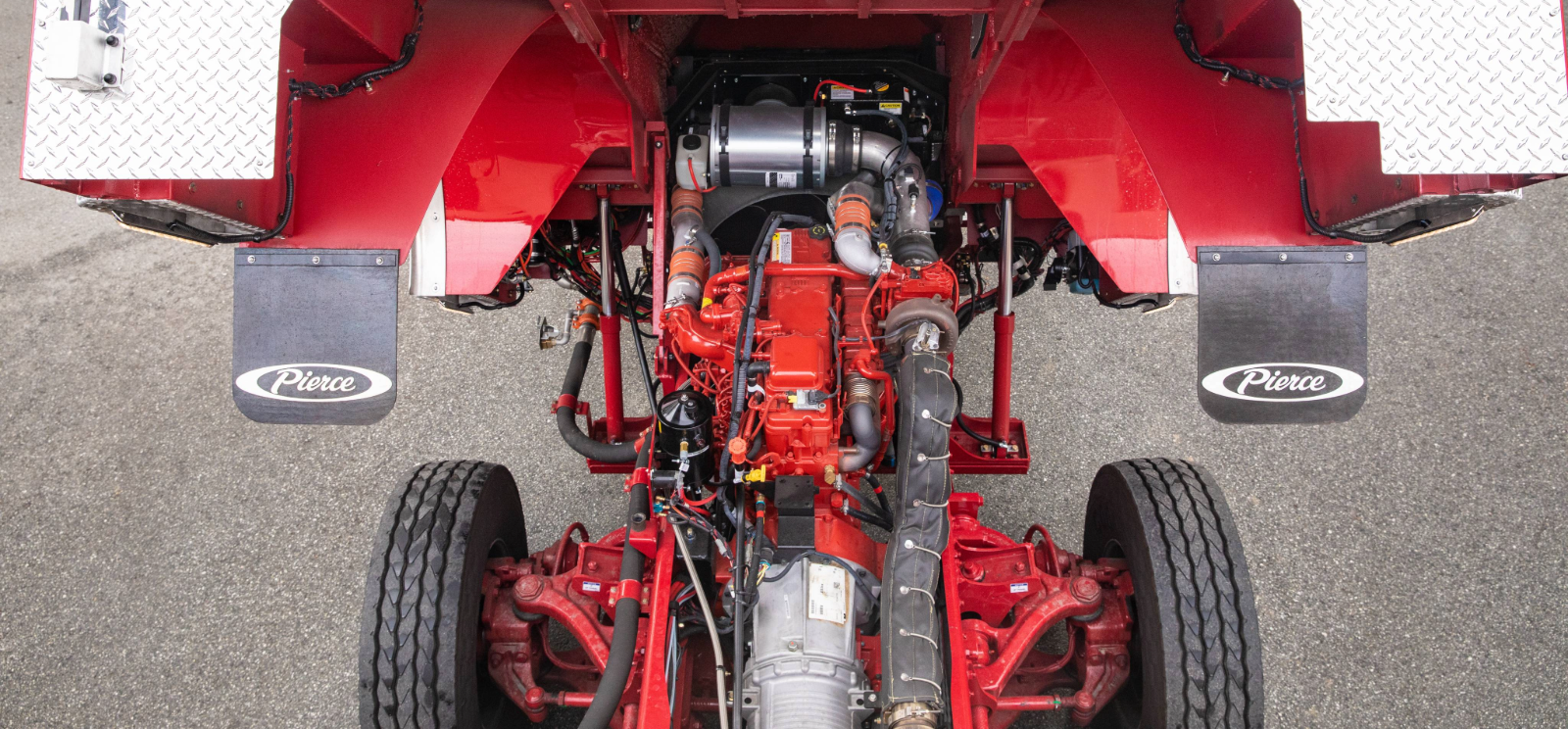 An overhead shot of the engine of a red Pierce fire apparatus.