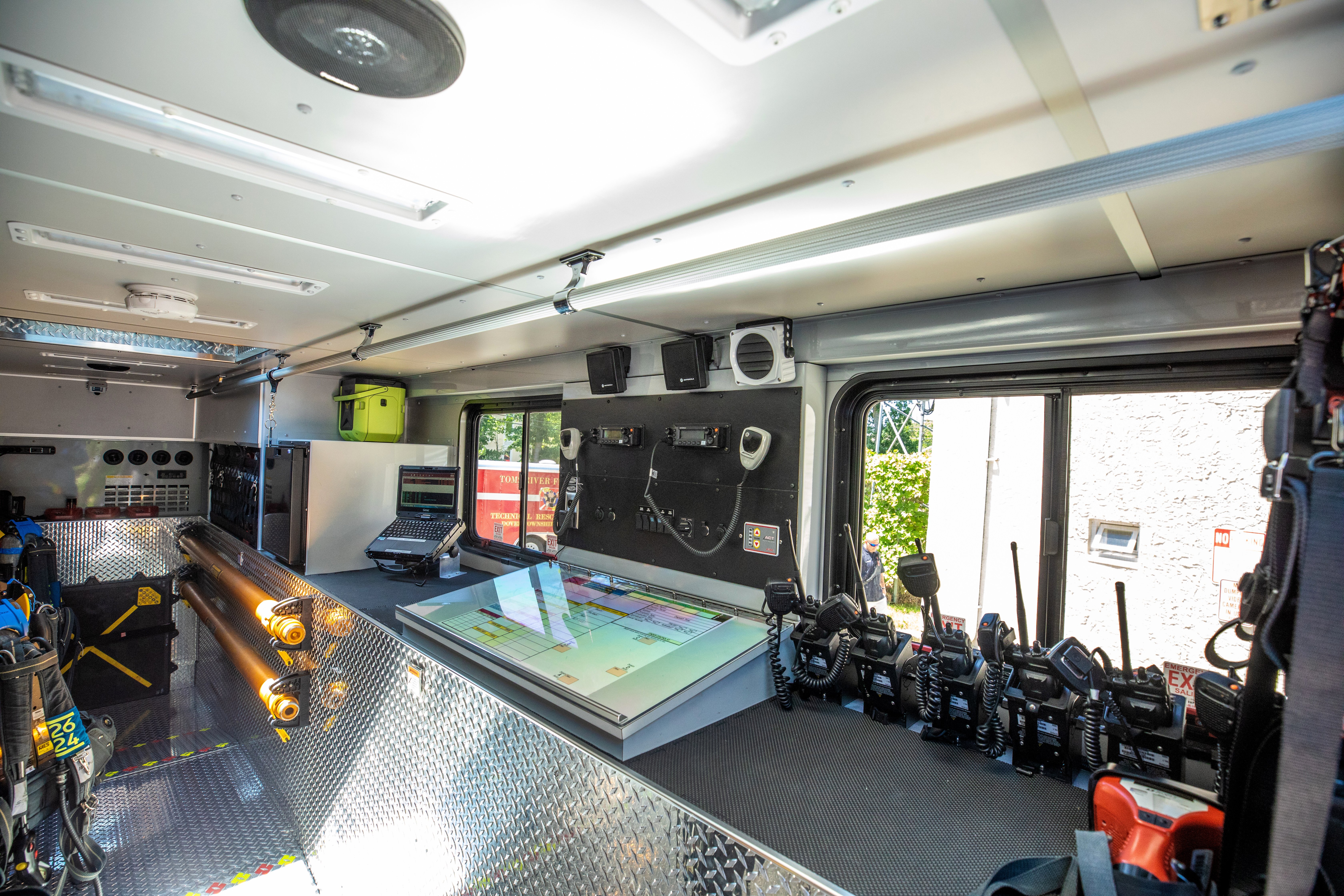 Interior layout of a Pierce Walk-In Heavy-Duty Rescue Fire Truck with a control system, counter space and windows. 