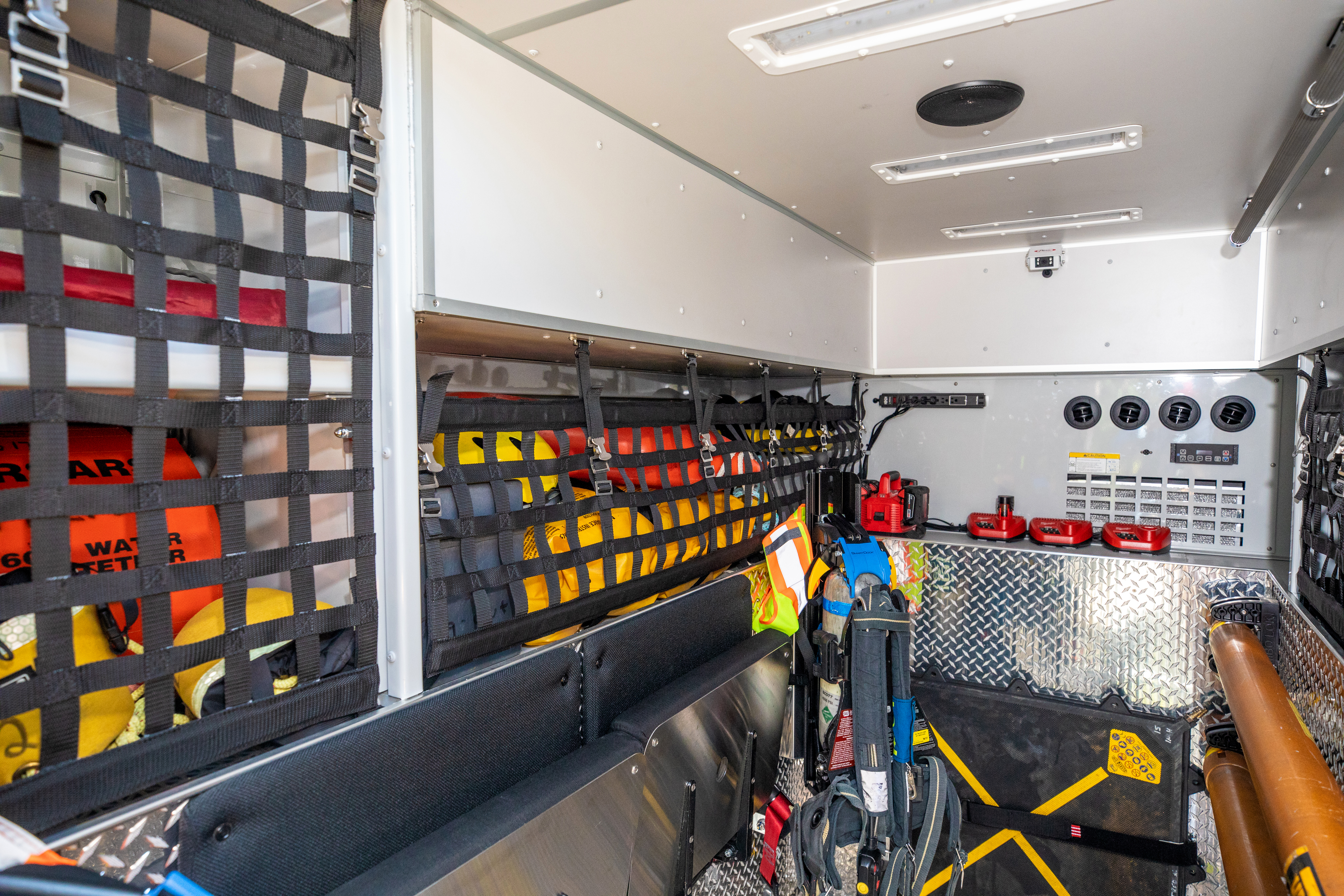 Interior of a Pierce Walk-In Heavy-Duty Fire Truck with storage compartments and firefighting equipment. 