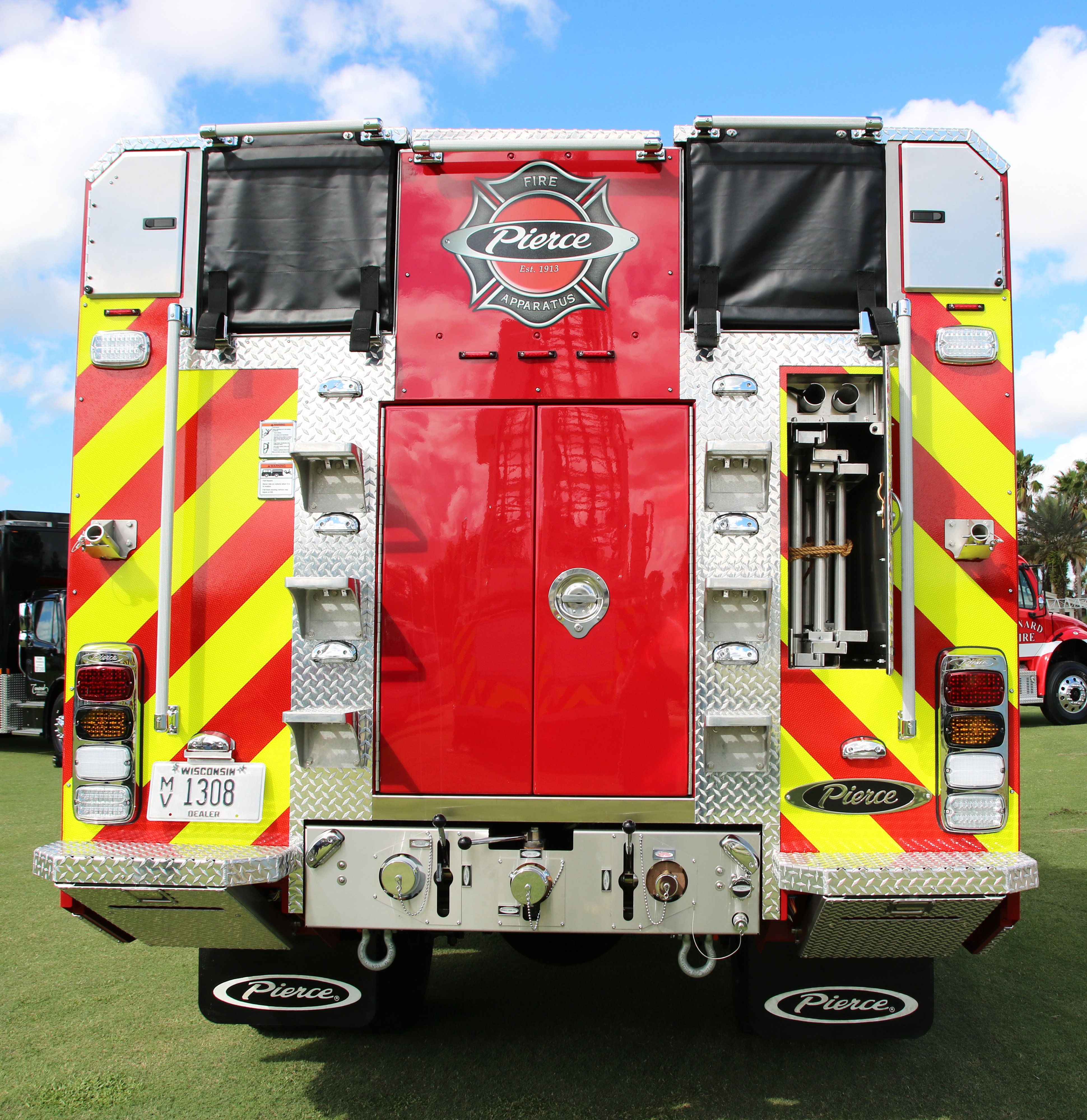 Rear of a Pierce BX™ Wildland Fire Truck parked outside on a sunny day. 