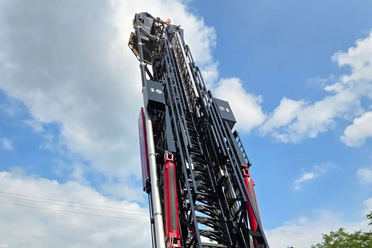 A Pierce fire truck aerial ladder extended high into the sky during a Pierce Road Rally demonstration.