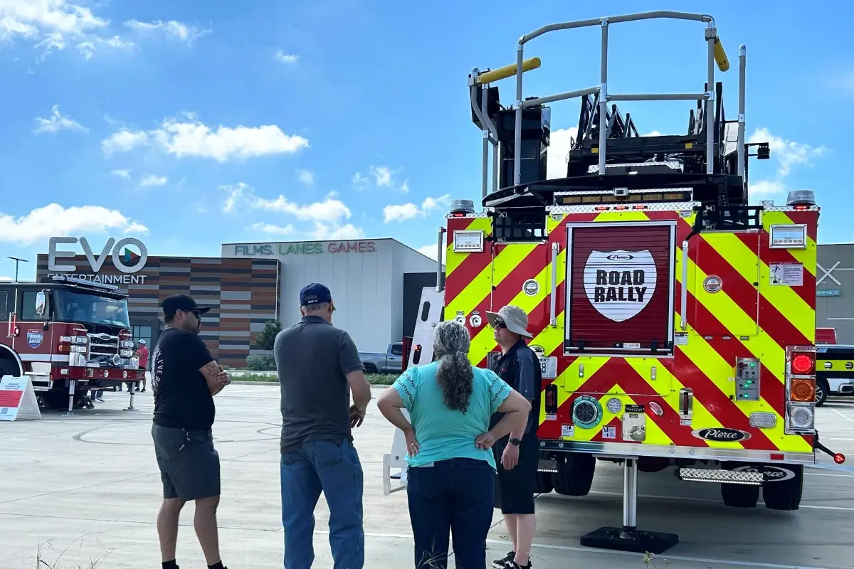 People gathered behind a Pierce fire truck during a Pierce Road Rally event.