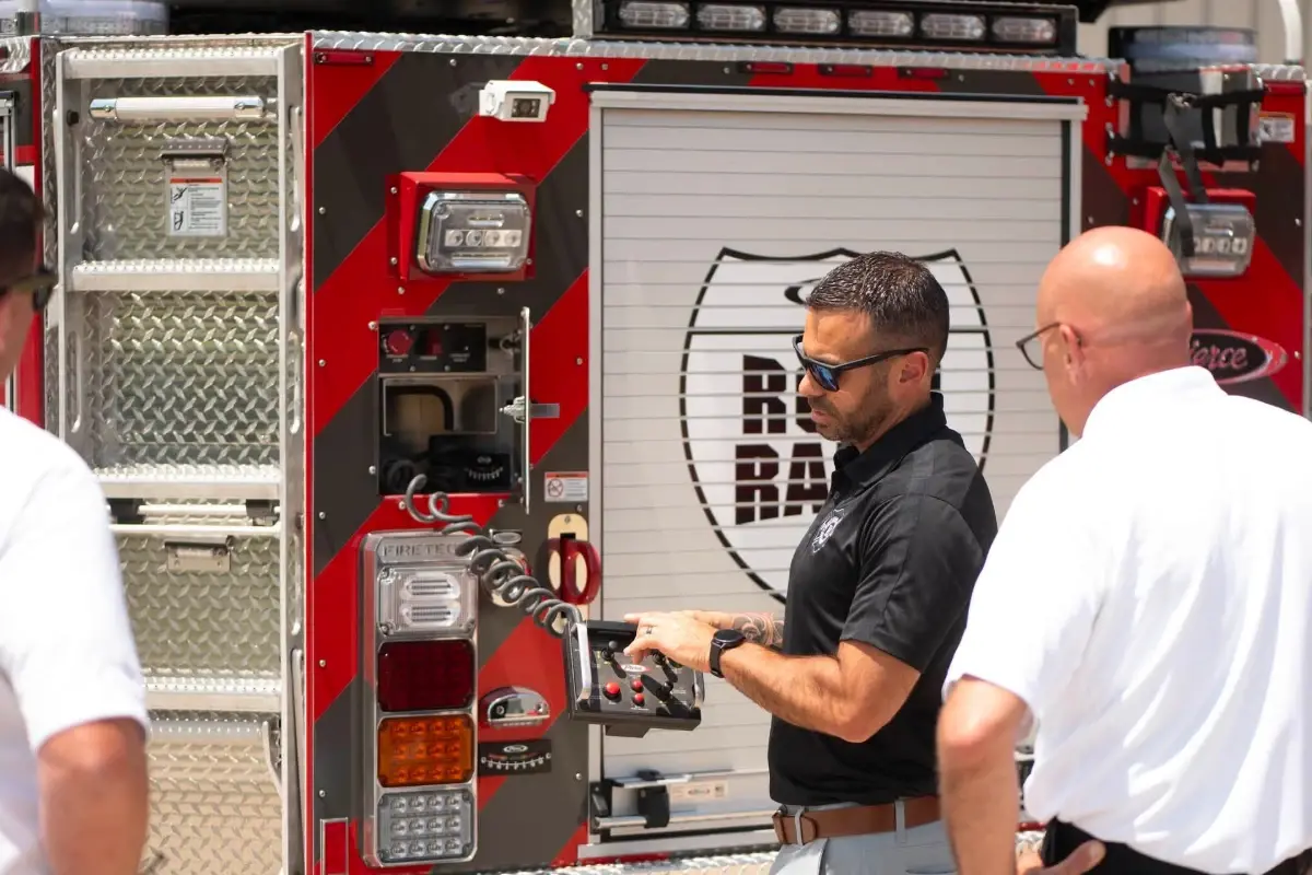 A man demonstrates a fire truck remote controller at the Pierce Road Rally.