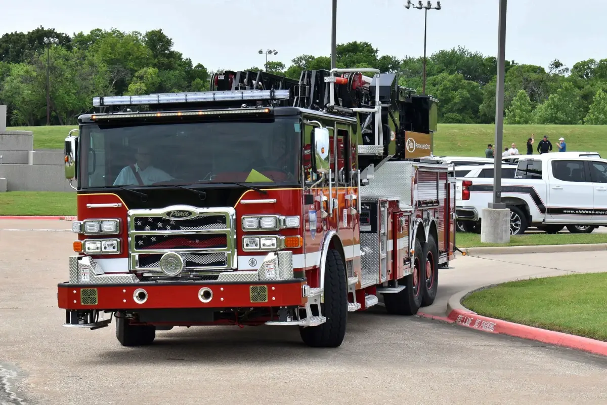 A red and black Pierce custom fire truck driving during the Pierce Road Rally.