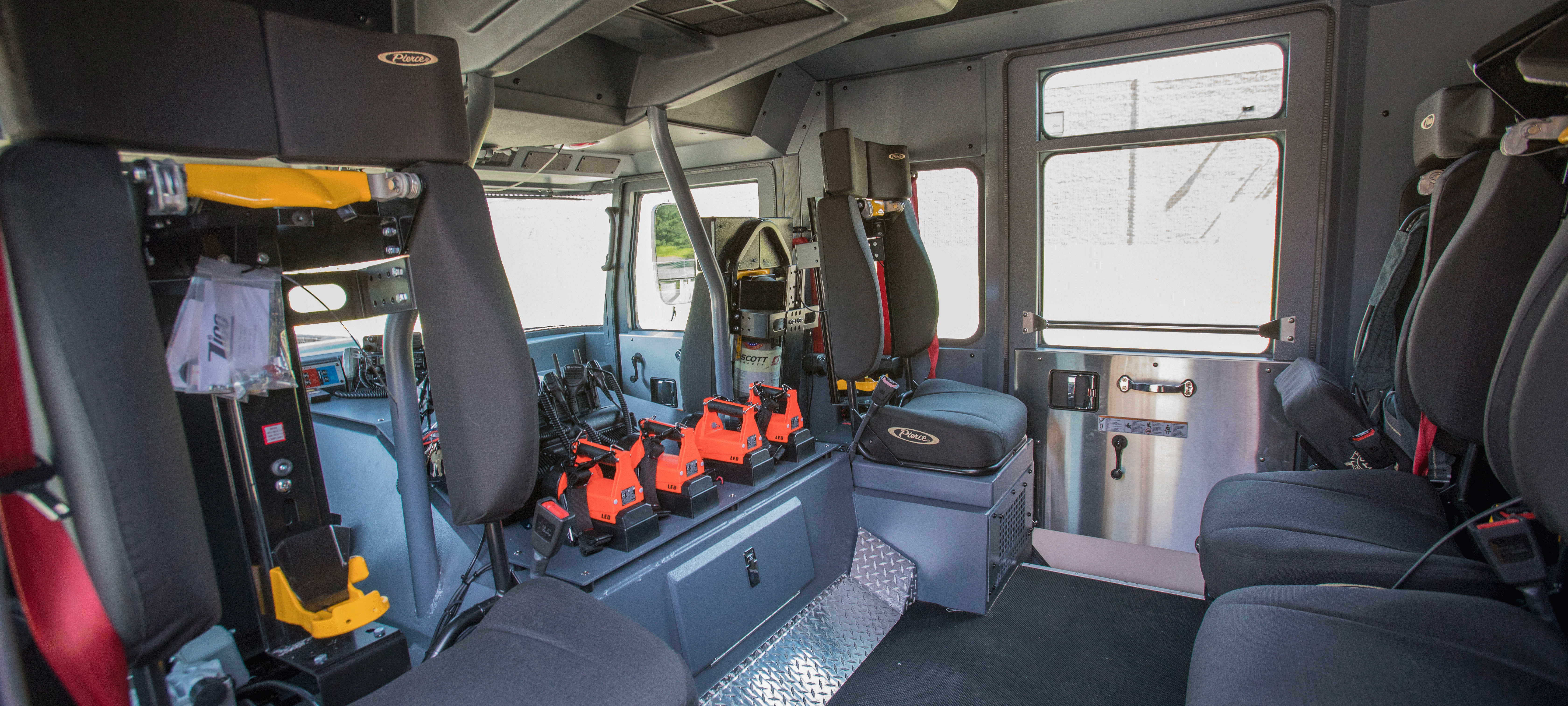 Interior chassis configuration with grey rear seating in a Pierce Saber custom fire truck. 