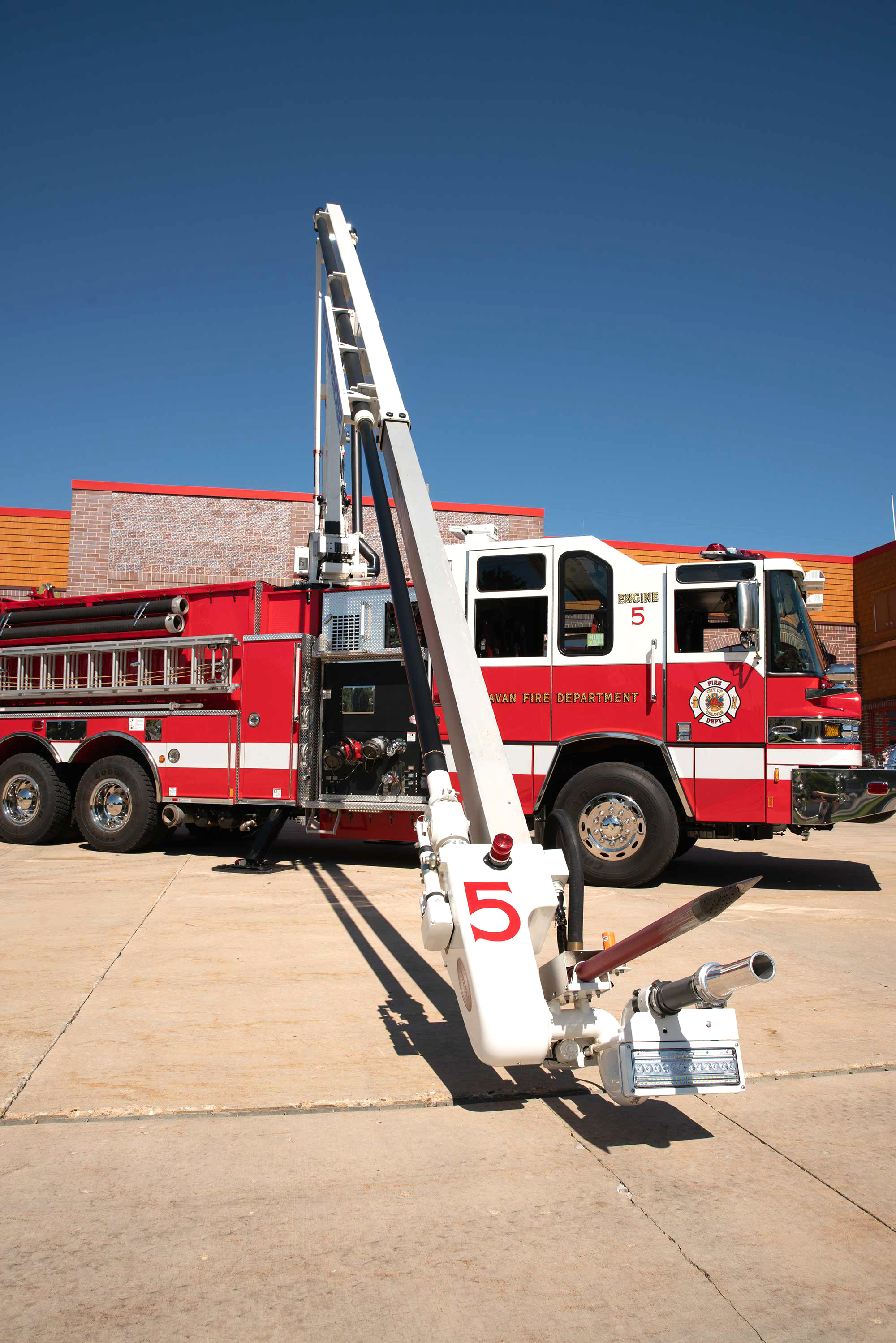 A Pierce Fire Truck outside on a sunny day in front of a Fire Station with a 36-inch Piercing Depth Snozzle. 