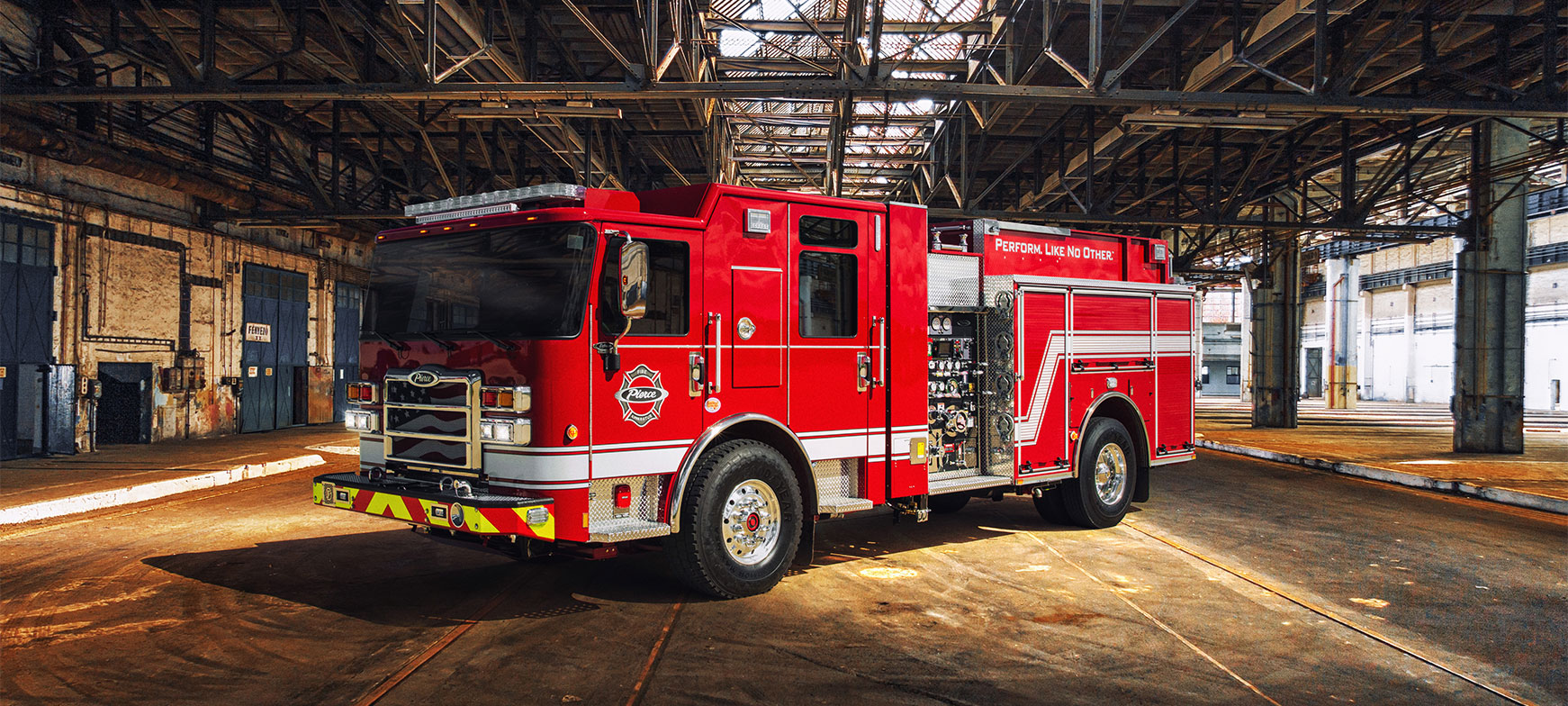The front drivers side of a Volterra electric fire truck parked in an industrial building.